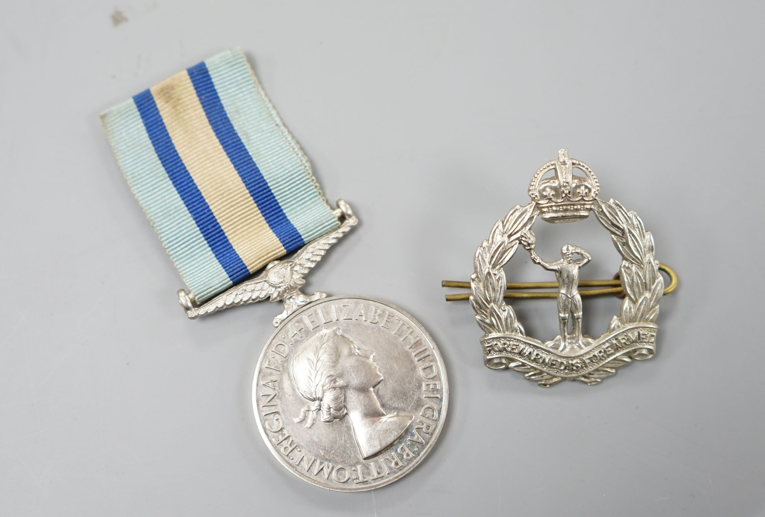 A QEII Royal Observer Corps Medal to 'CHIEF OBSERVER J. OSBORNE’ and a cap badge